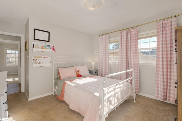 bedroom featuring light colored carpet