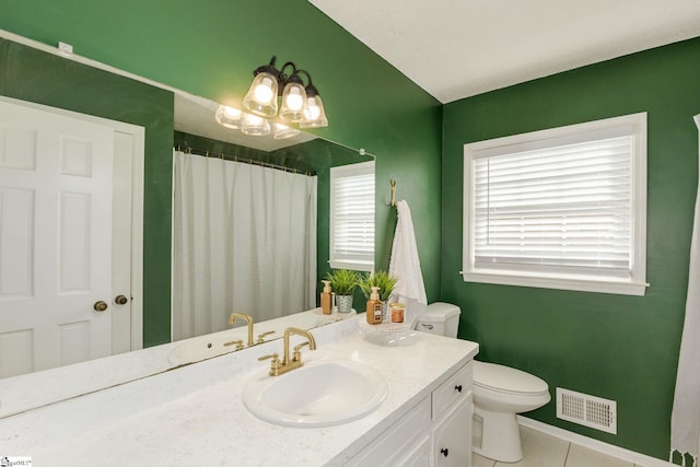 bathroom featuring tile patterned flooring, vanity, and toilet