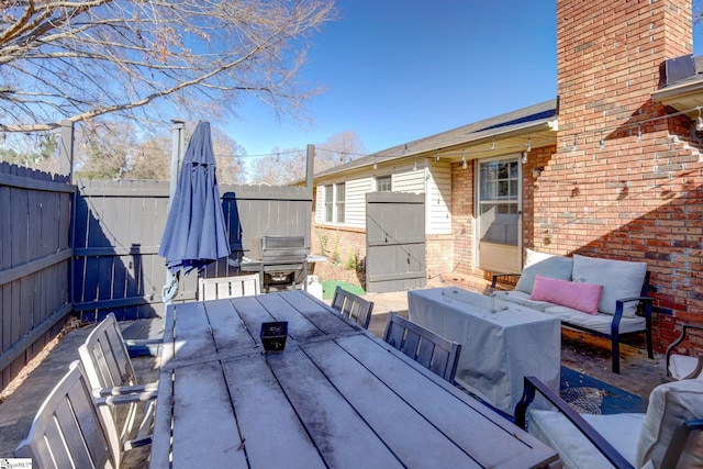 deck featuring a patio and a grill