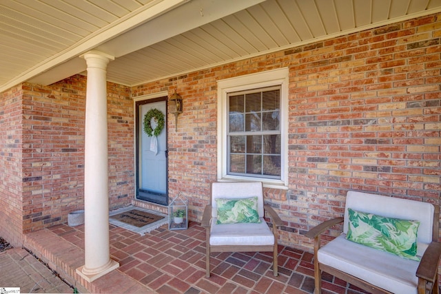 view of exterior entry featuring covered porch