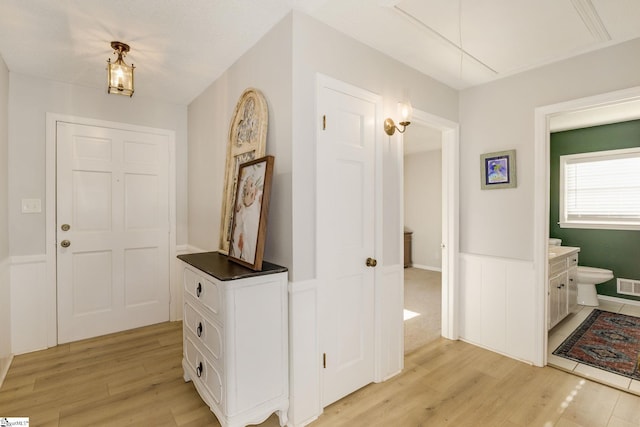 hall with light hardwood / wood-style flooring