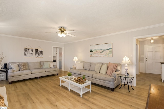 living room featuring ceiling fan, crown molding, and light hardwood / wood-style floors