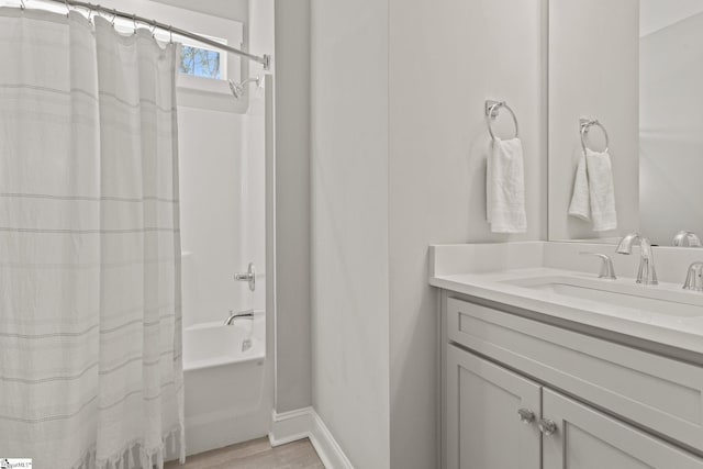 bathroom with shower / bath combo with shower curtain and vanity