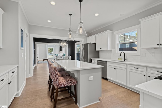 kitchen featuring white cabinets, stainless steel appliances, and a kitchen island