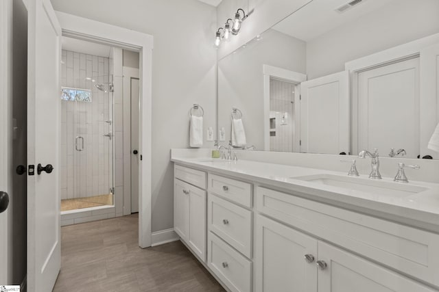 bathroom featuring vanity and a shower with shower door