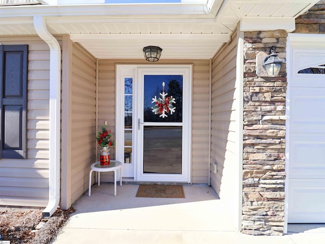 view of exterior entry featuring a garage