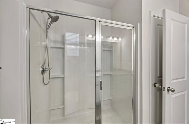 bathroom with a shower with door