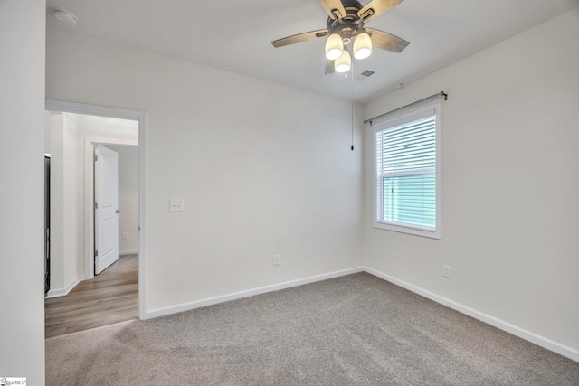 unfurnished room with ceiling fan and light colored carpet