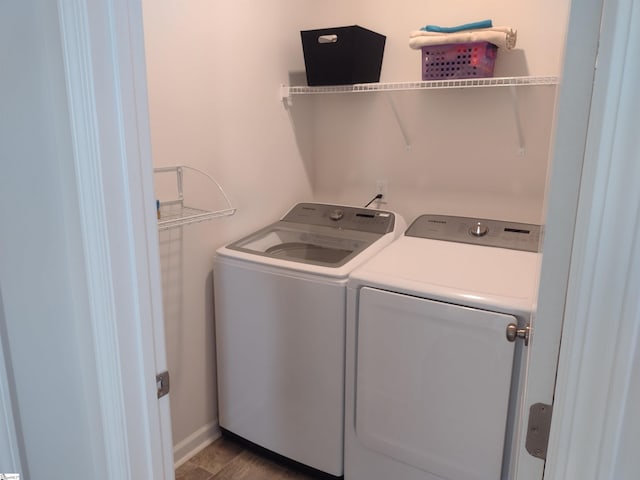 laundry room featuring washing machine and dryer and wood-type flooring