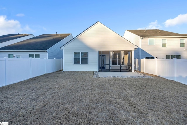 back of property with a sunroom and a patio area