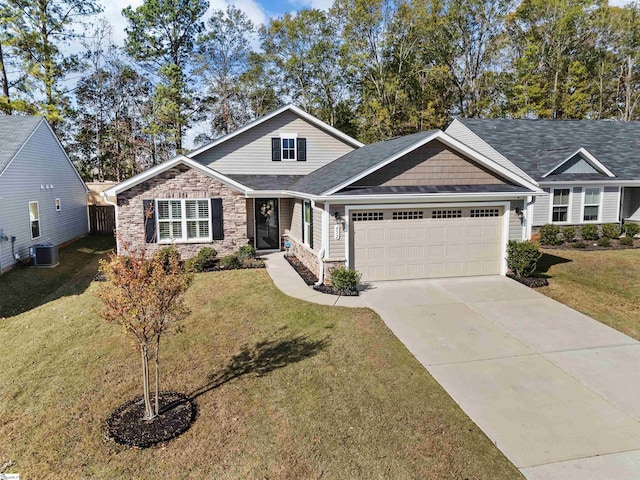 craftsman house featuring a front yard, a garage, and central AC unit