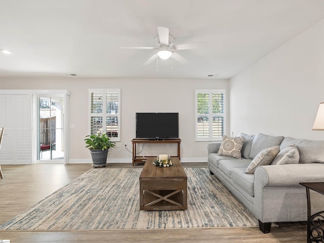 living room with hardwood / wood-style floors and ceiling fan