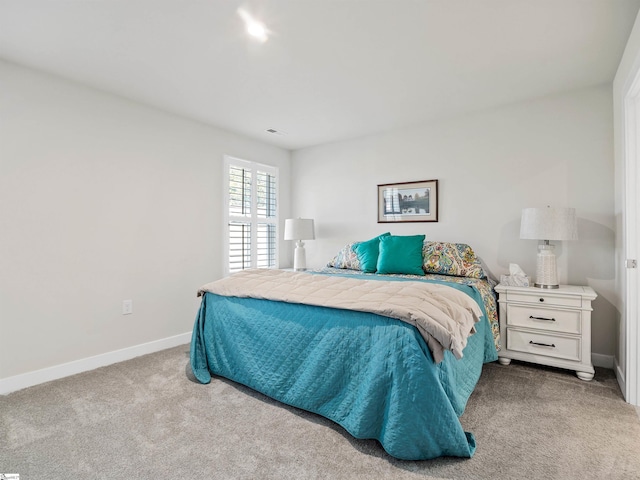 bedroom featuring light carpet