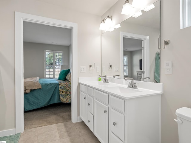 bathroom featuring tile patterned flooring, vanity, and toilet