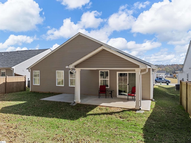 rear view of house featuring a patio area and a yard