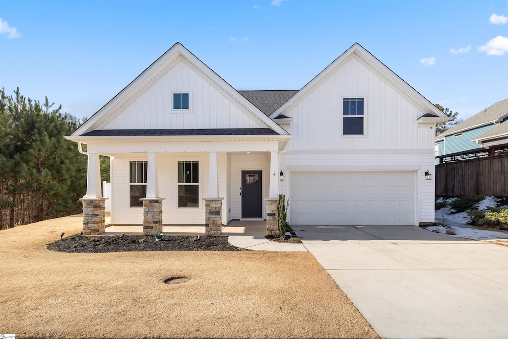 view of front of home with covered porch and a garage