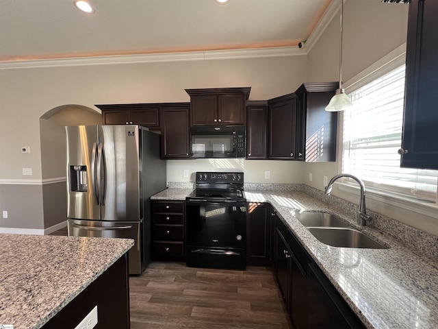 kitchen with black appliances, crown molding, sink, light stone countertops, and decorative light fixtures