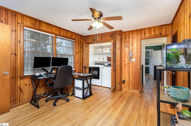 office with wood walls, washer and dryer, ceiling fan, and light hardwood / wood-style floors