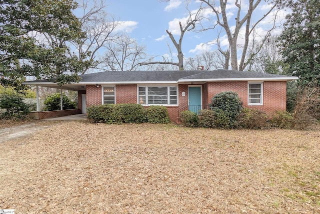 ranch-style home featuring a carport