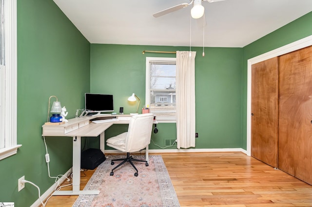 office space featuring ceiling fan and light wood-type flooring