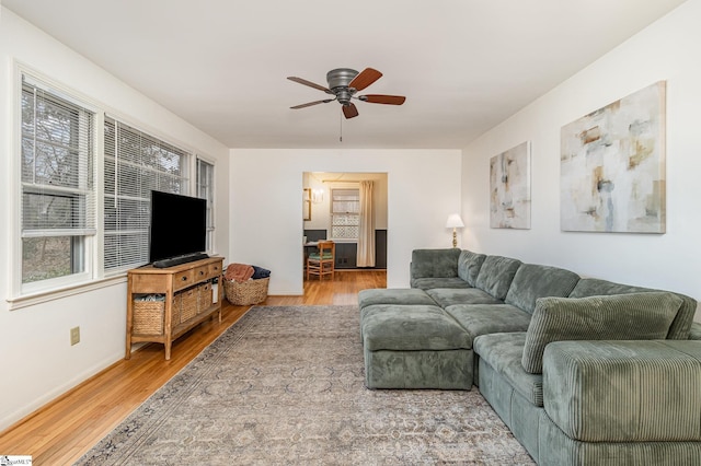 living room featuring ceiling fan and hardwood / wood-style floors