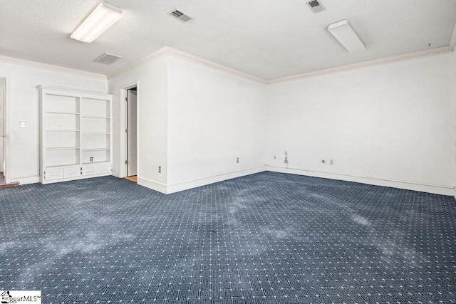 carpeted empty room featuring crown molding, built in features, and a textured ceiling