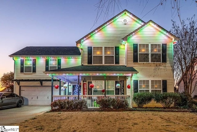 view of front of home featuring covered porch and a garage