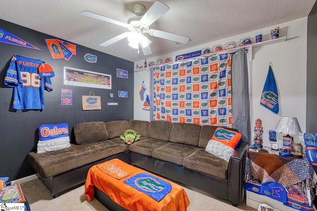 living room featuring carpet flooring, ceiling fan, and a textured ceiling