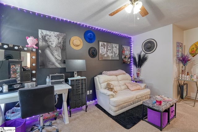 carpeted office space featuring a textured ceiling and ceiling fan