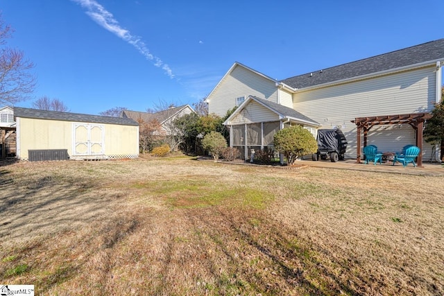 view of yard with a pergola, a storage unit, a patio area, and a sunroom