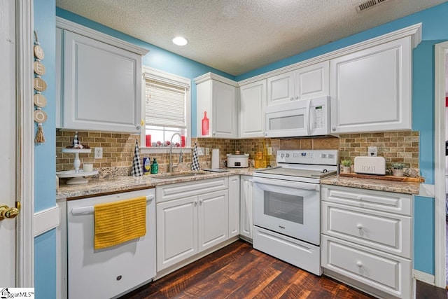 kitchen featuring white cabinetry, sink, dark wood-type flooring, a textured ceiling, and white appliances