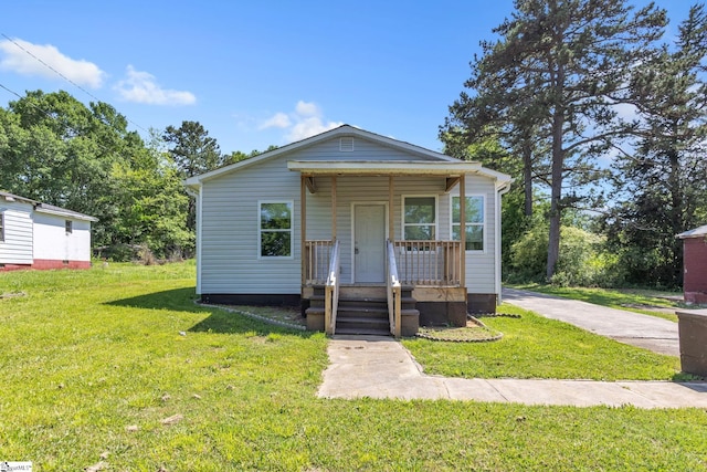 bungalow-style home with a porch and a front lawn