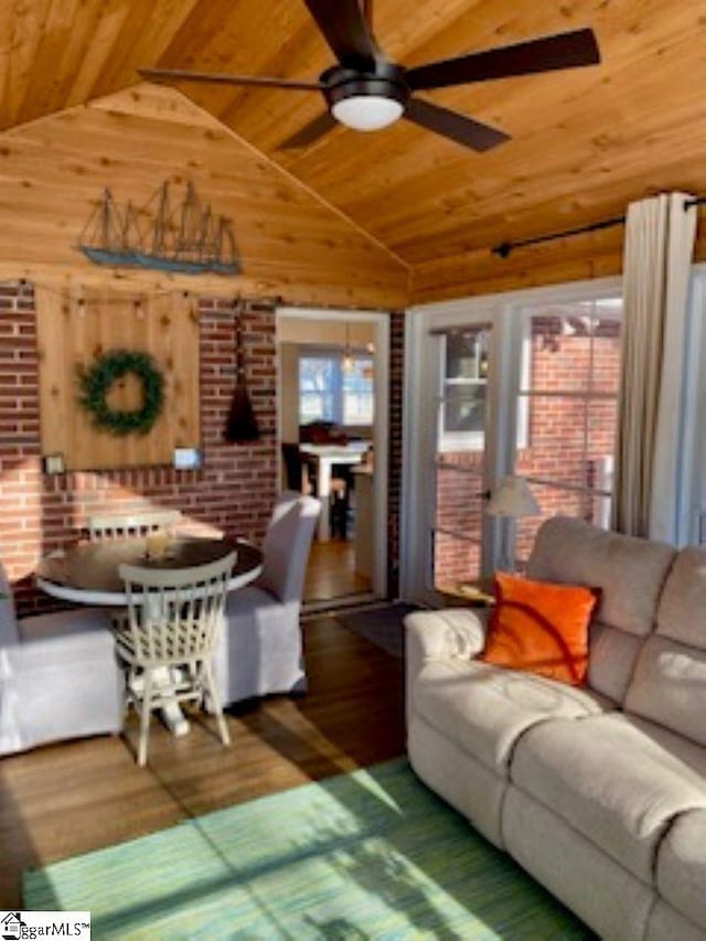 living room with vaulted ceiling, ceiling fan, wooden walls, wood-type flooring, and wooden ceiling