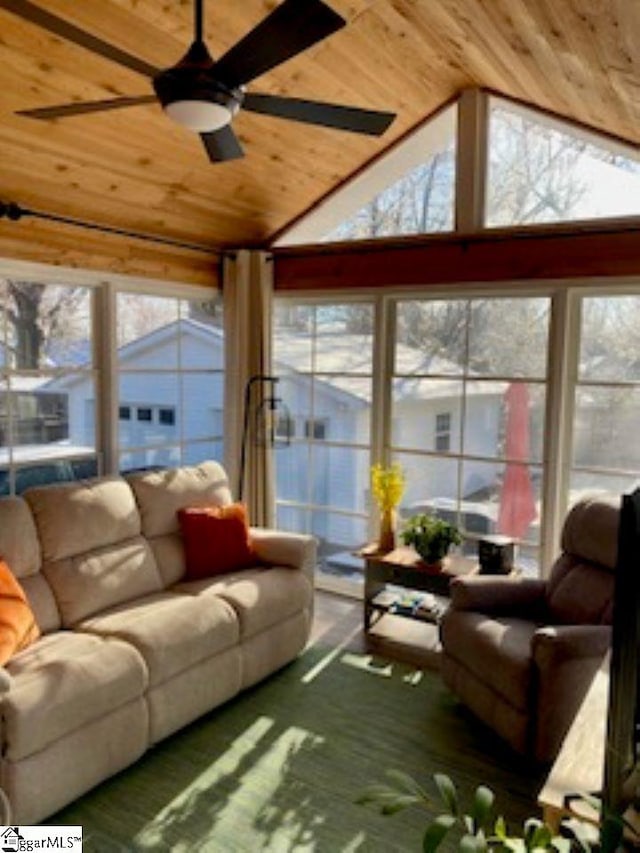 sunroom / solarium with ceiling fan, wood ceiling, and vaulted ceiling