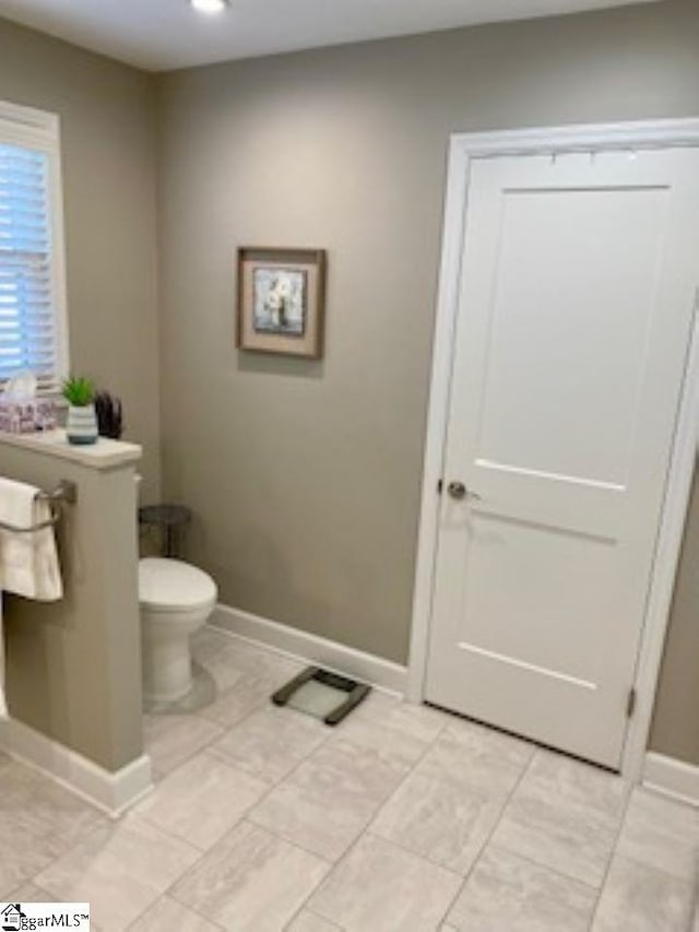 bathroom with tile patterned flooring and toilet