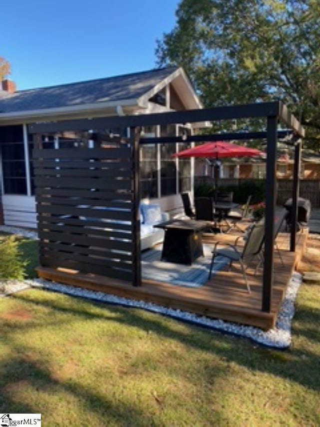 wooden deck featuring a yard