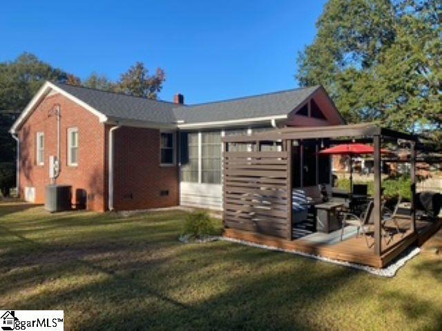 rear view of property featuring a yard