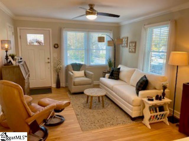 living room featuring ceiling fan, crown molding, and hardwood / wood-style flooring