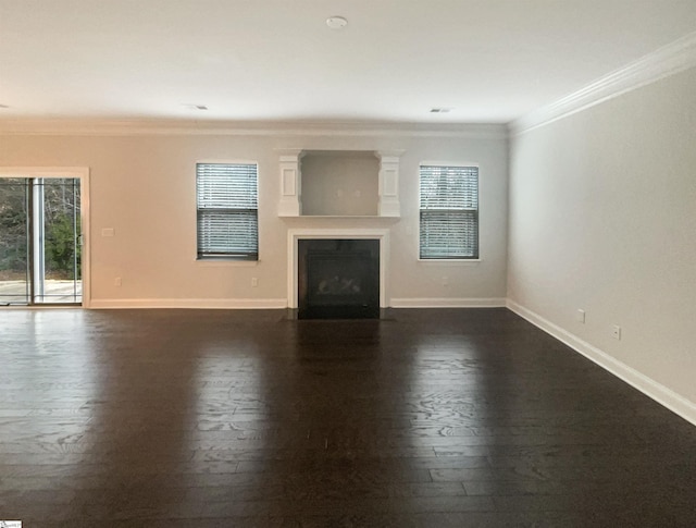 unfurnished living room with ornamental molding and dark hardwood / wood-style flooring