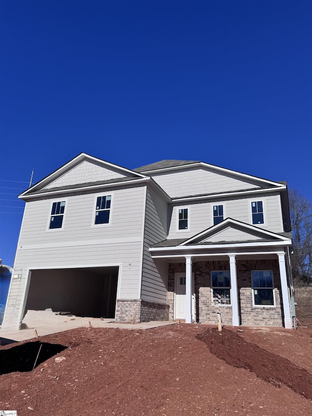 view of front of house with covered porch and a garage