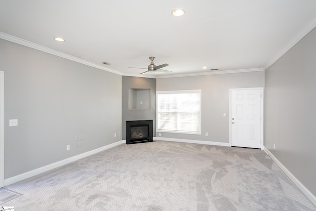 unfurnished living room with light colored carpet, ceiling fan, and crown molding