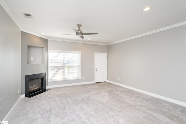 unfurnished living room featuring ceiling fan, light colored carpet, and ornamental molding