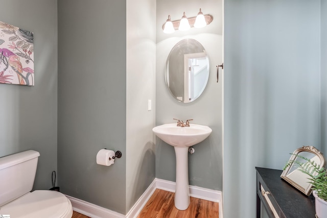 bathroom featuring hardwood / wood-style flooring and toilet