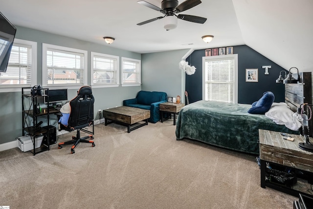 carpeted bedroom with multiple windows, vaulted ceiling, and ceiling fan