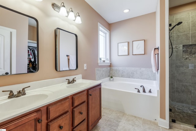 bathroom with vanity and independent shower and bath