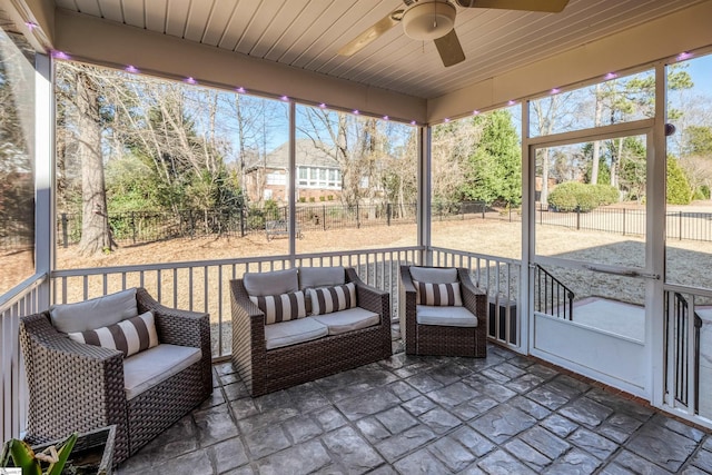 unfurnished sunroom with ceiling fan and wooden ceiling