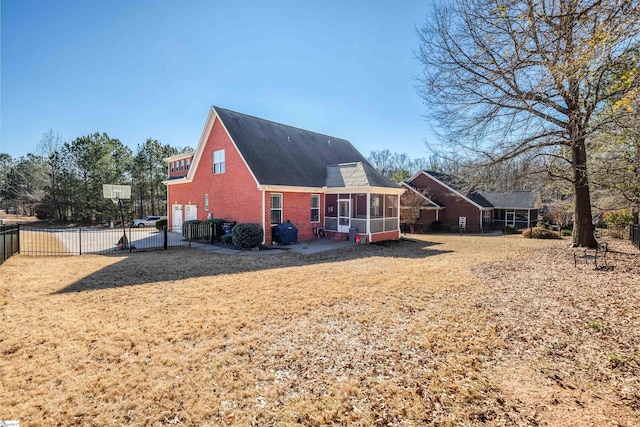 back of property with a sunroom