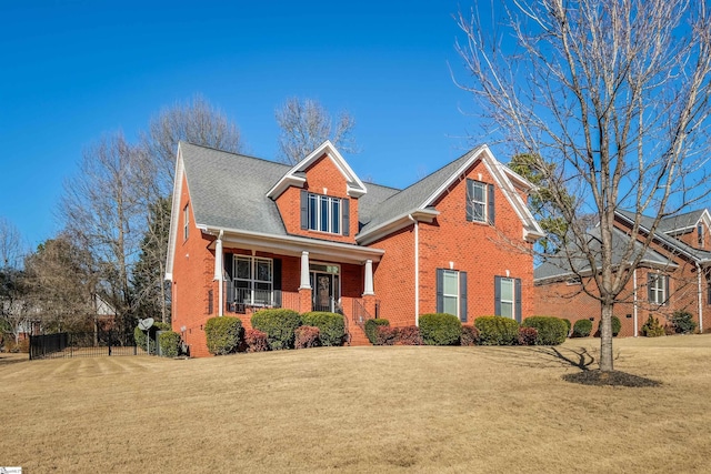 view of property with covered porch and a front yard