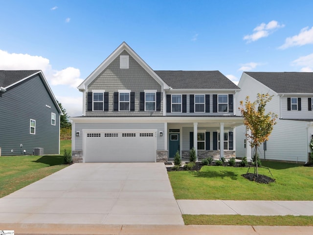 view of front of property featuring cooling unit, covered porch, a front yard, and a garage