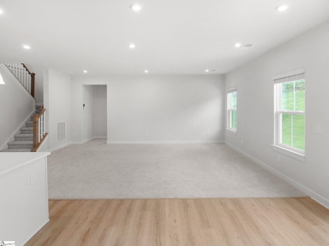 unfurnished room with light carpet